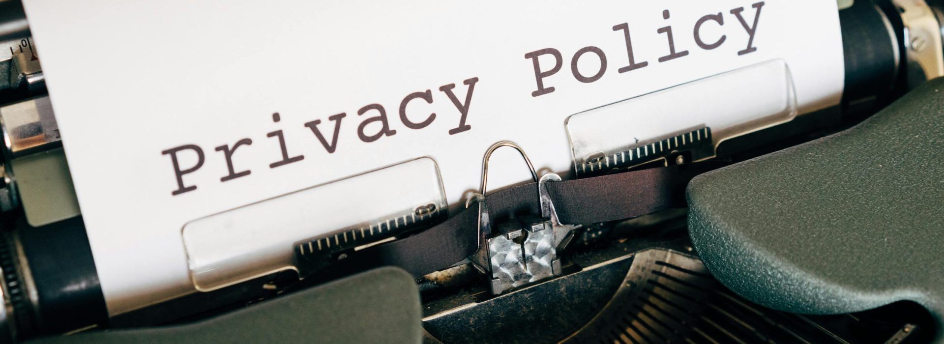 pexels-photo-4152513-4152513 A vintage typewriter writing 'Privacy Policy' on paper, capturing an old-school conceptual theme.